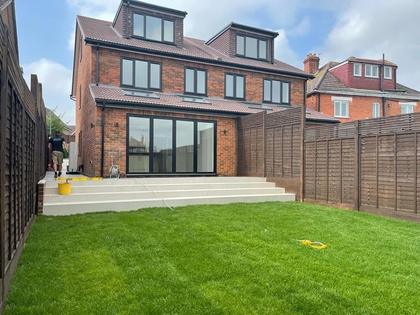 Rear of a brick house with a loft conversion and a ground-floor extension
