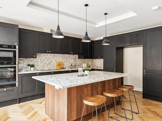 Fitted kitchen with island and stone worktops