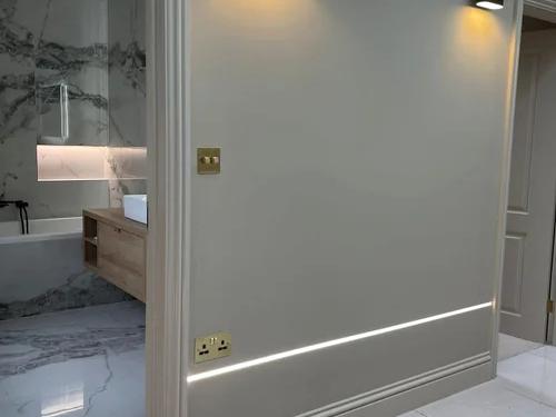 Hallway with wall lights and recessed skirting lighting